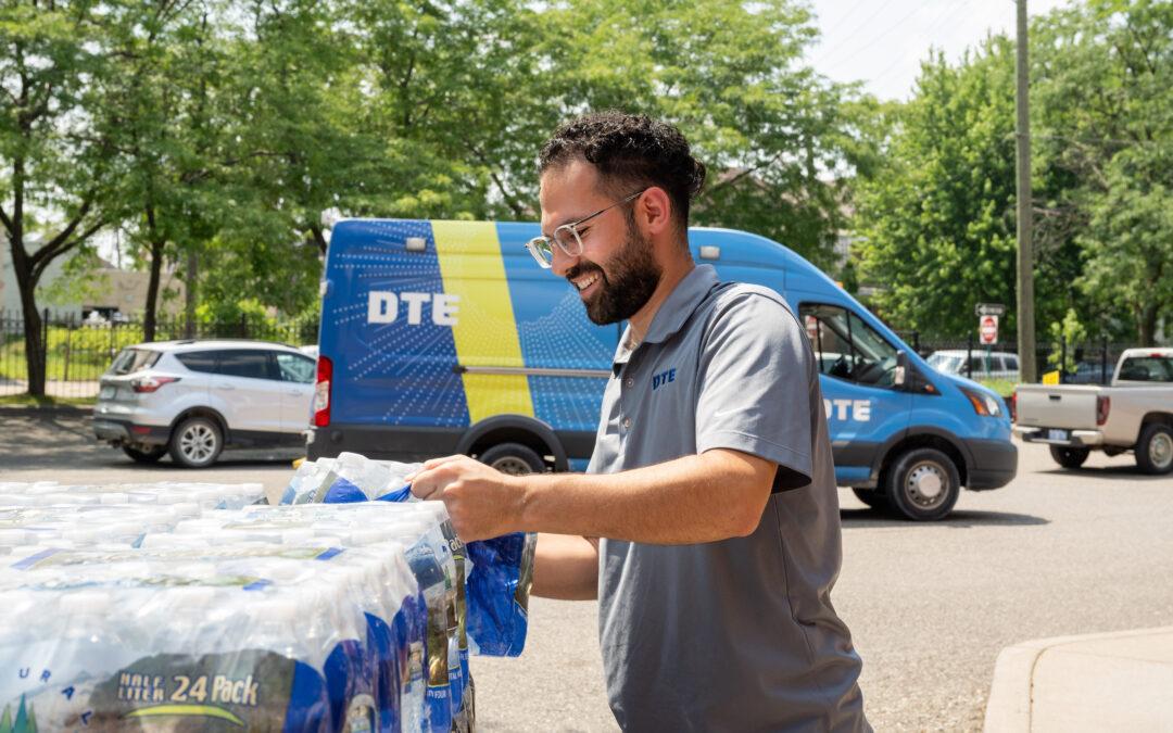 DTE employee unloading a water delivery at a community partner location