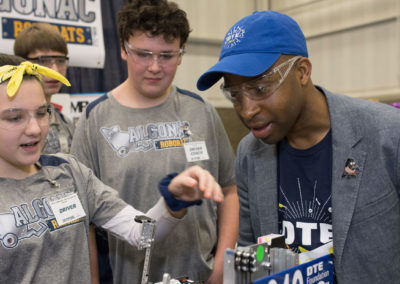 Team 5860 shows DTE's Philip Smith their robot