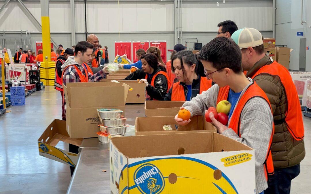 DTE volunteers pack food at Forgotten Harvest