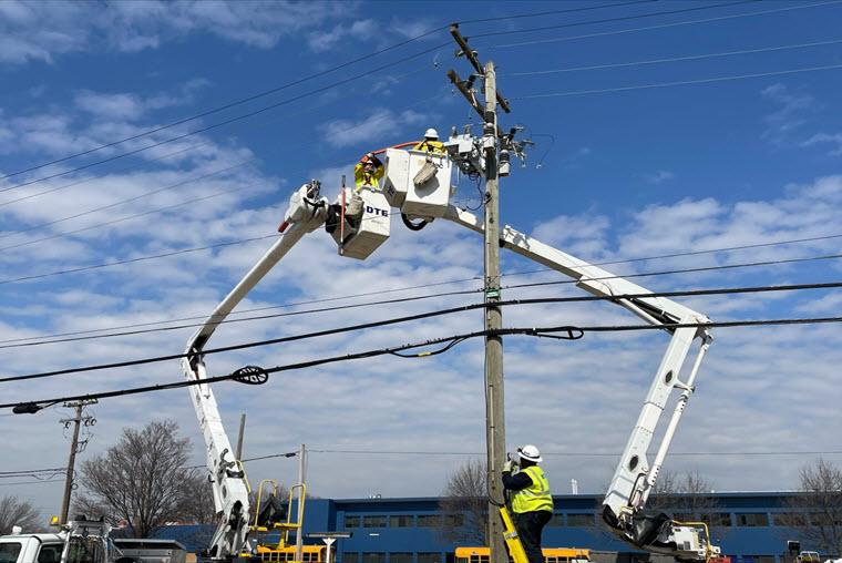 DTE worker up in bucket truck working on a utility pole in Garden City Michigan