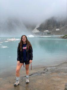 Kelsey DeCarteret hiking near mountains and water